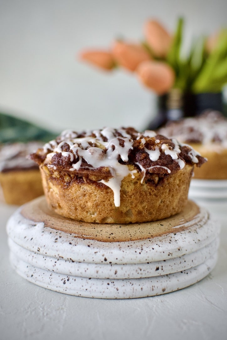 Glazed Apple Streusel Muffins on a table displayed and ready to eat.