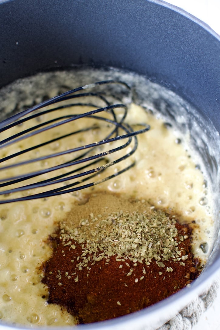 Onion roux, adding spices to the pan.