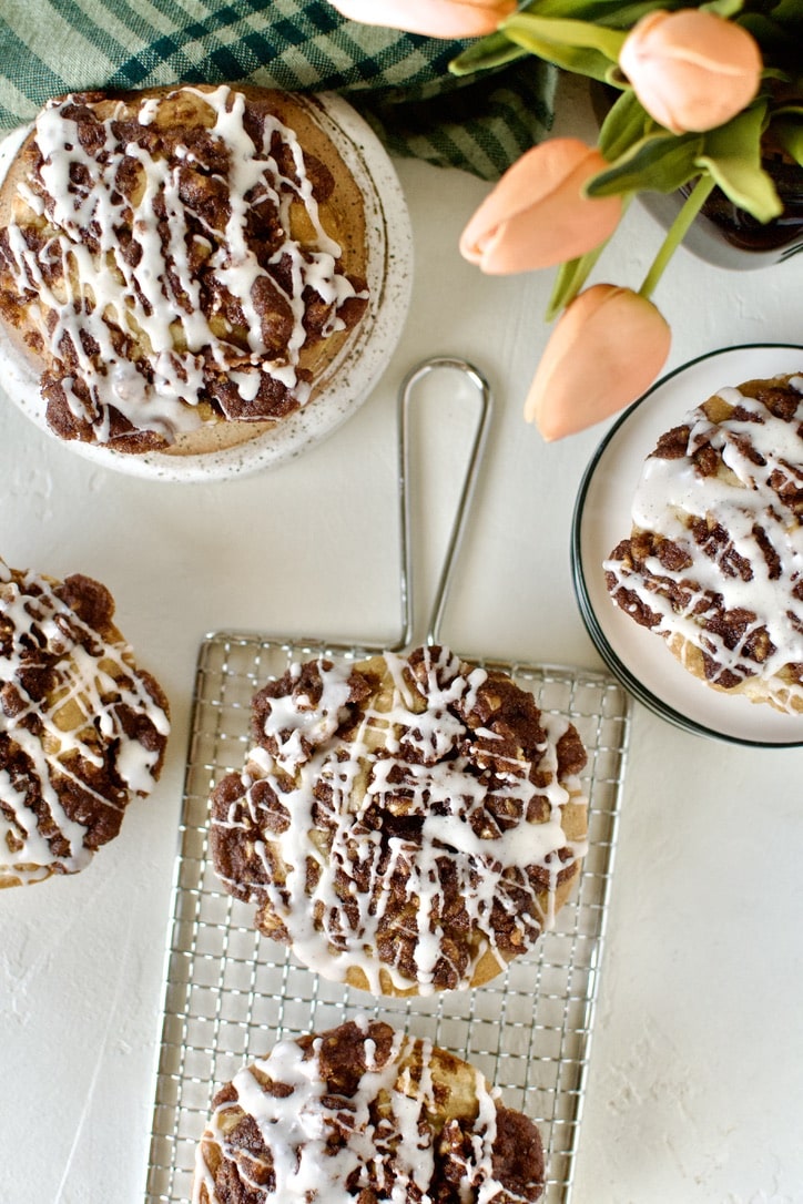 Glazed Apple Streusel Muffins on a table displayed and ready to eat.