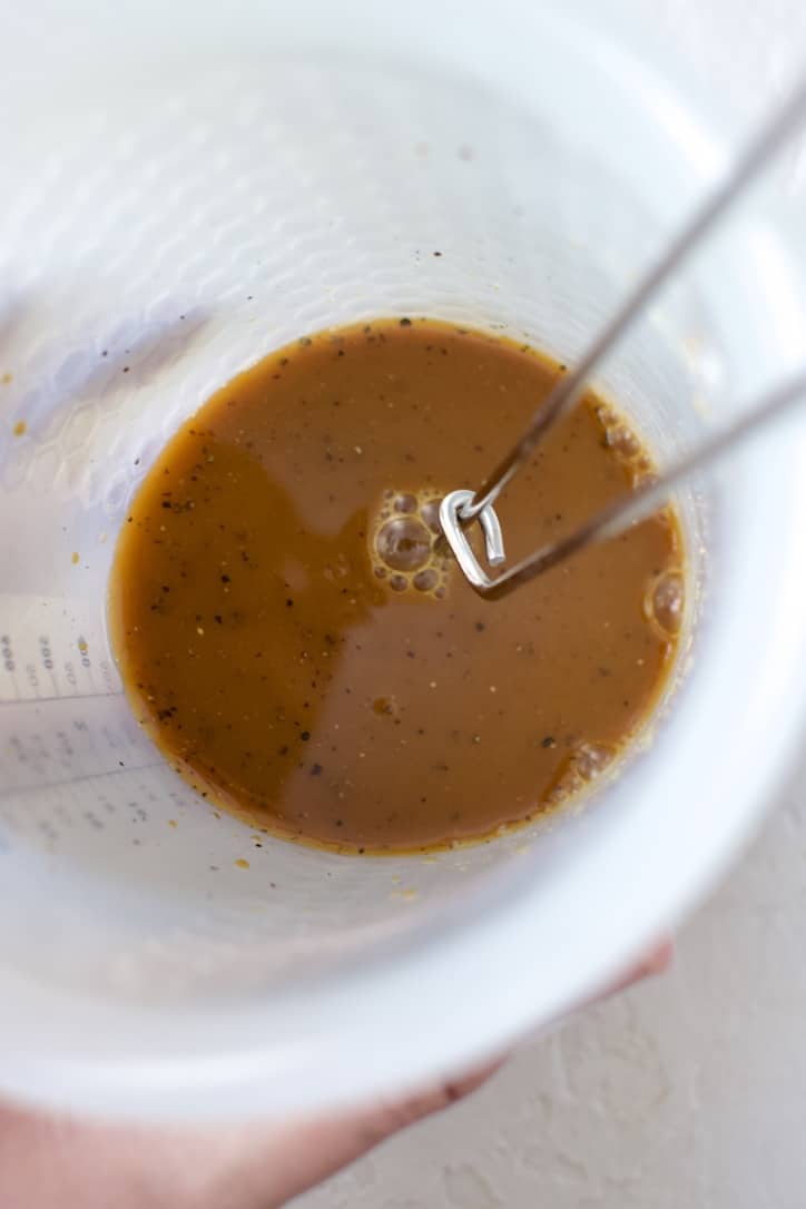 Whisking up the sauce ingredients with cornstarch in a measuring cup.