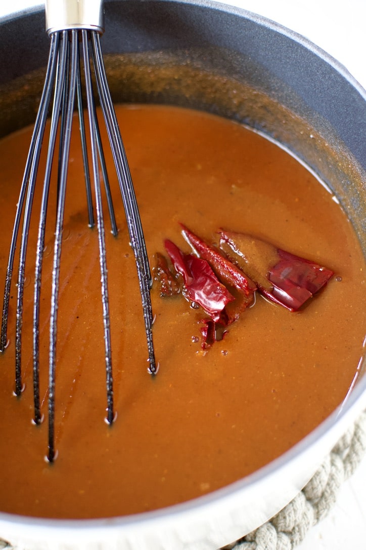 Liquid ingredients added to the pot and allowing it to simmer for a while.