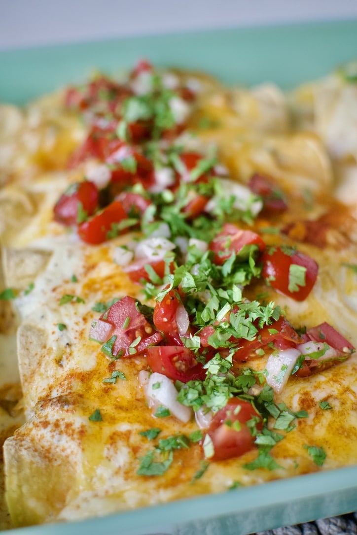 Chicken Enchiladas with Sour Cream Sauce after baking and topped with pico de gallo and cilantro.