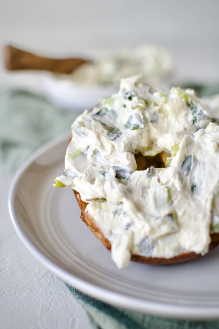 Finished scallion cream cheese spread on a bagel and ready to eat!