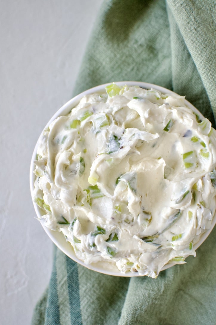 Finished scallion cream cheese in a dish ready to eat.