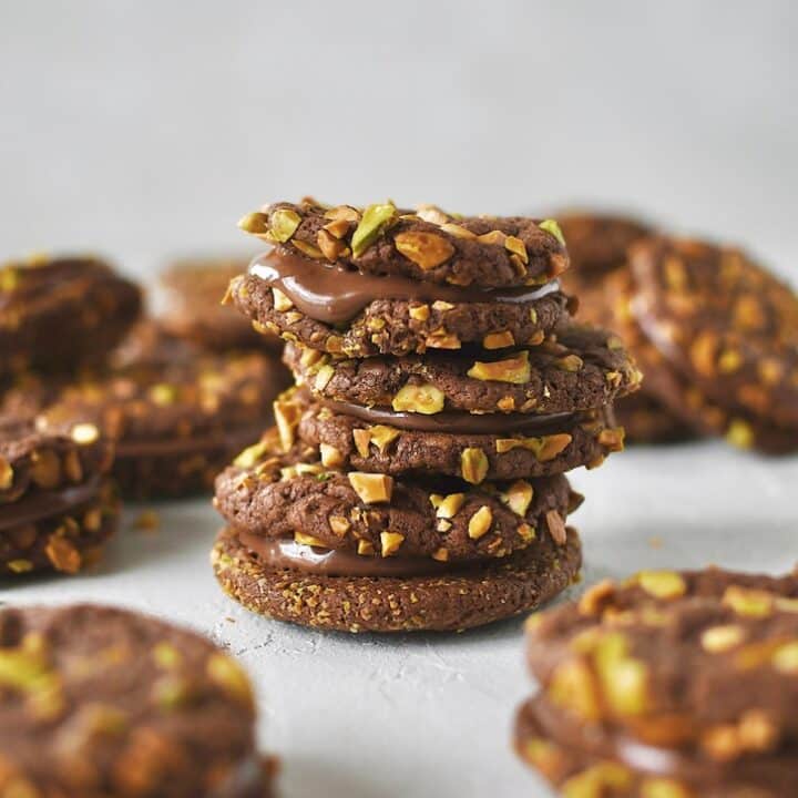 Finished Pistachio Cookies sandwiched together with nutella and stacked together.