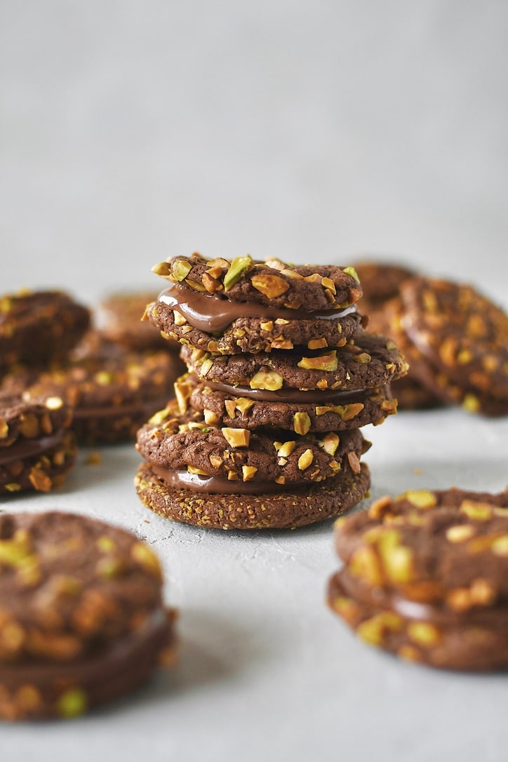 Finished Pistachio Cookies sandwiched together with nutella and stacked together.