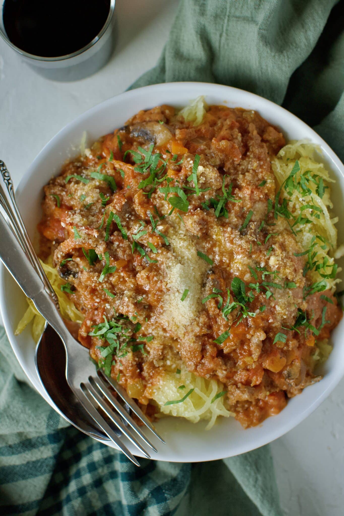 Sausage Bolognese served over roasted spaghetti squash and topped with parmesan cheese and basil.