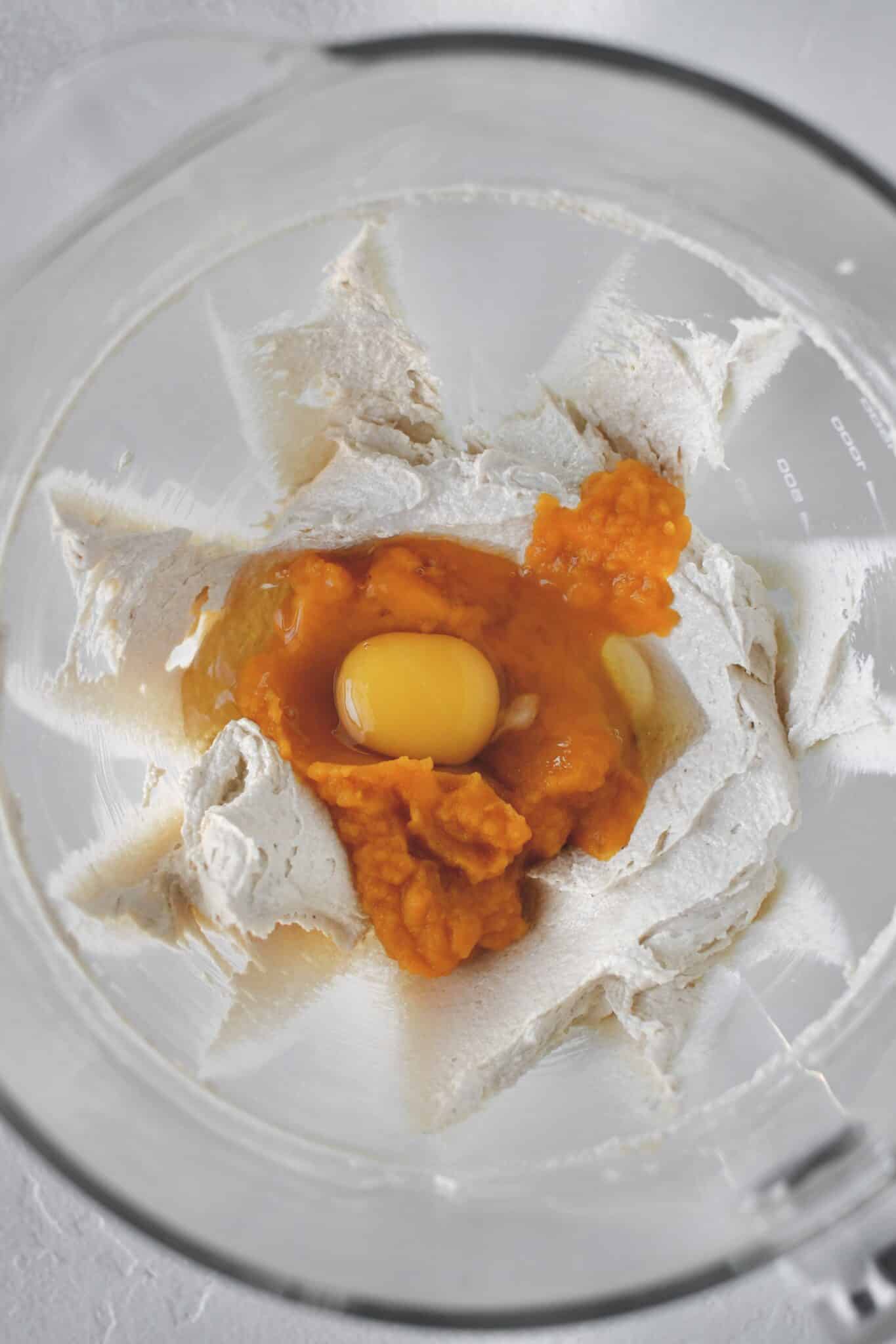 Creamed butter and sugar in the bowl of a stand mixer, adding the pumpkin and egg.