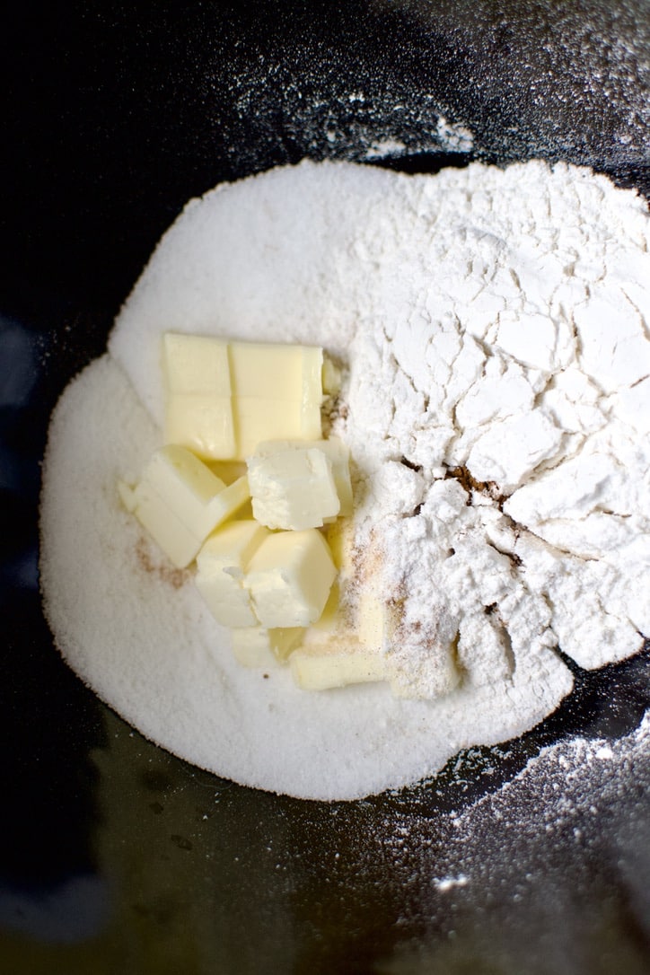 Dry ingredients and butter in a mixing bowl before forming the crumble.