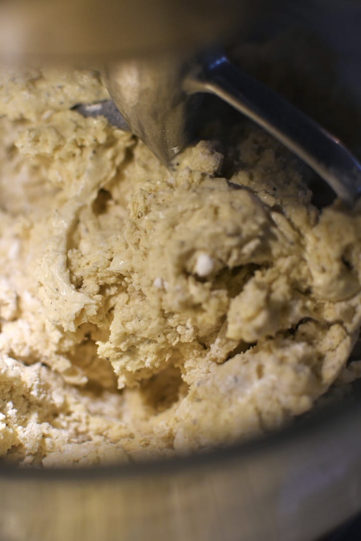 Mixing the dry ingredients into the wet for the cookies.