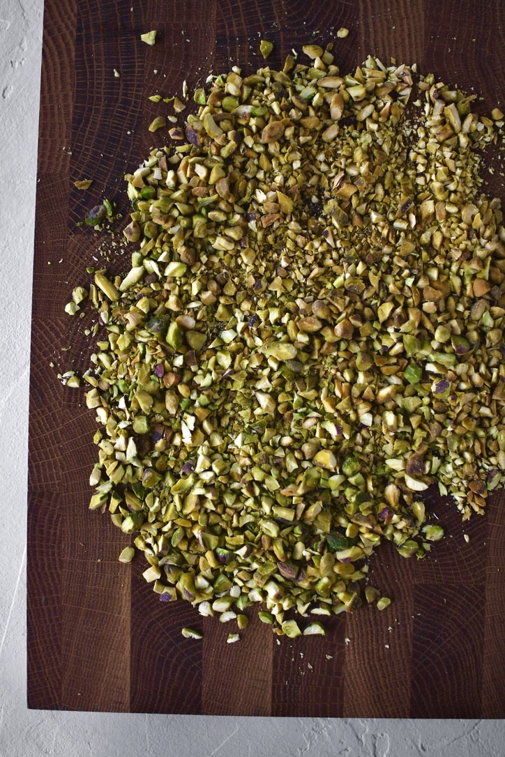 Chopped pistachios on a cutting board.