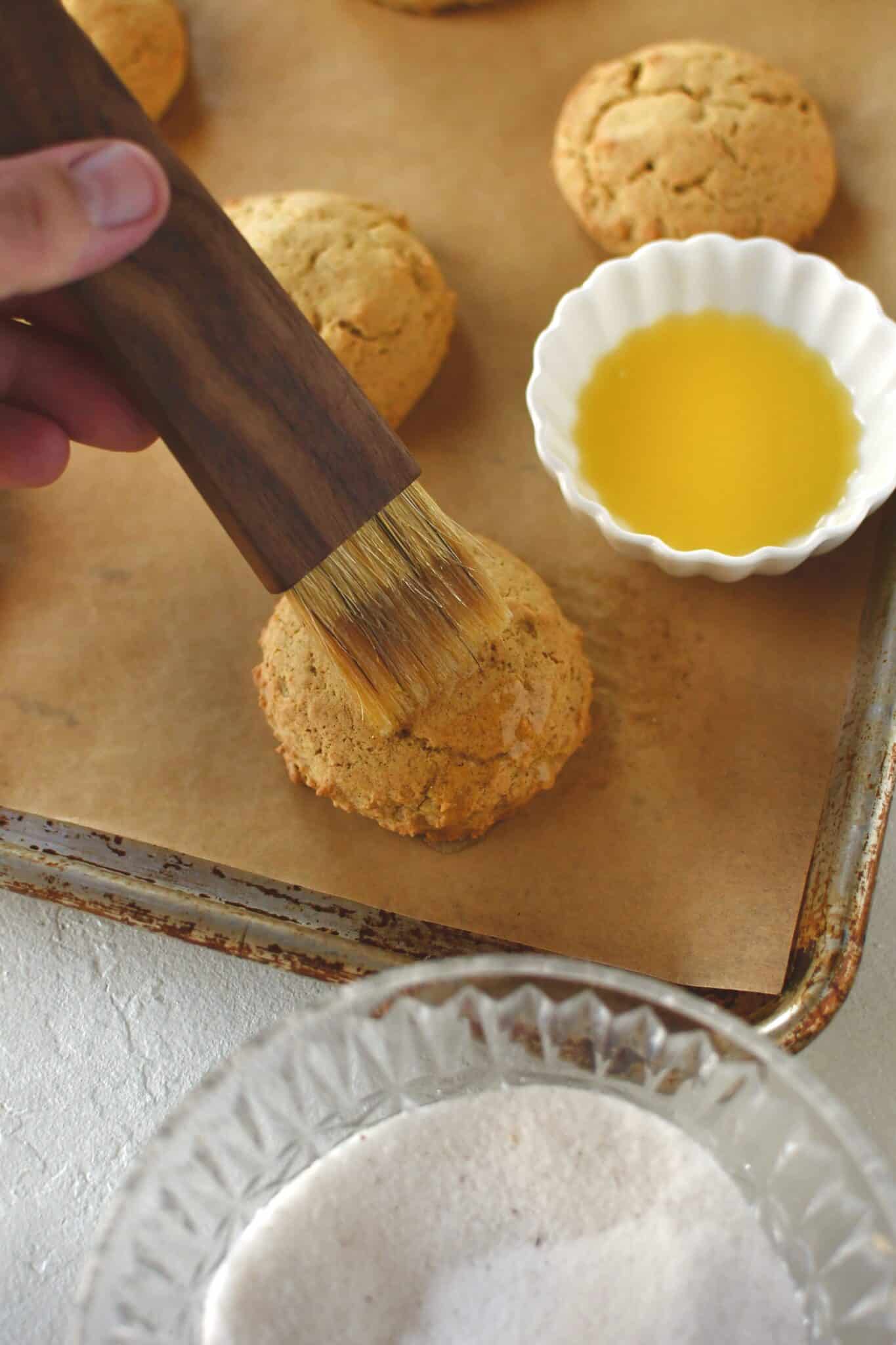 Brushing the tops of cooled whoopie pies with melted butter.