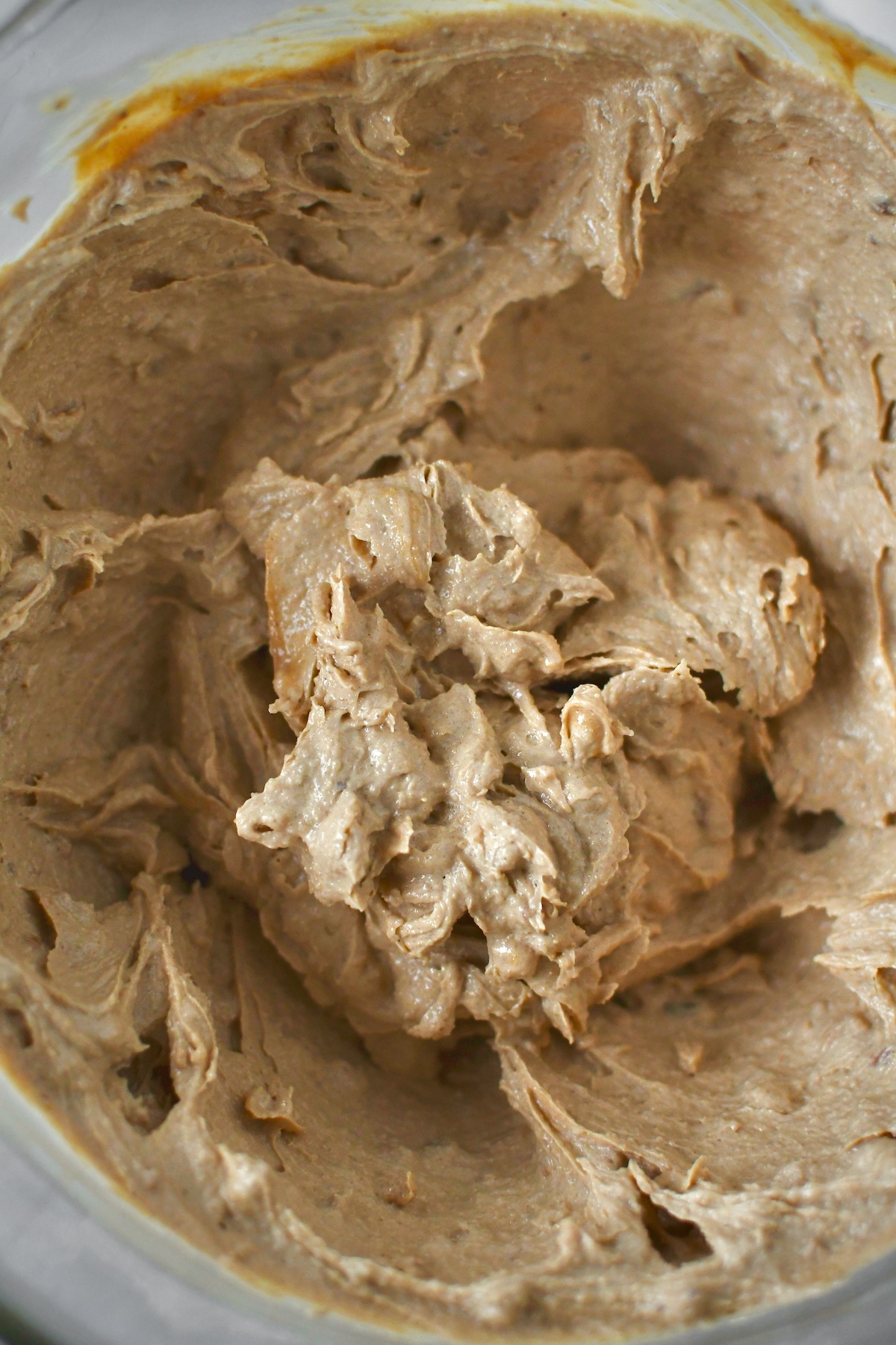 Creamed butters and sugars in a stand mixer bowl.
