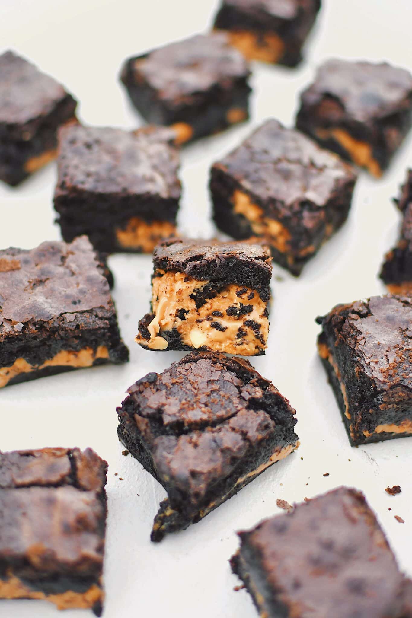 Peanut Butter Brownies scattered on a platter, cut and ready to eat.