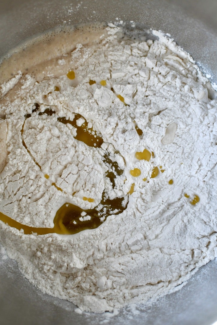 Flour and olive oil added to warm water and yeast.