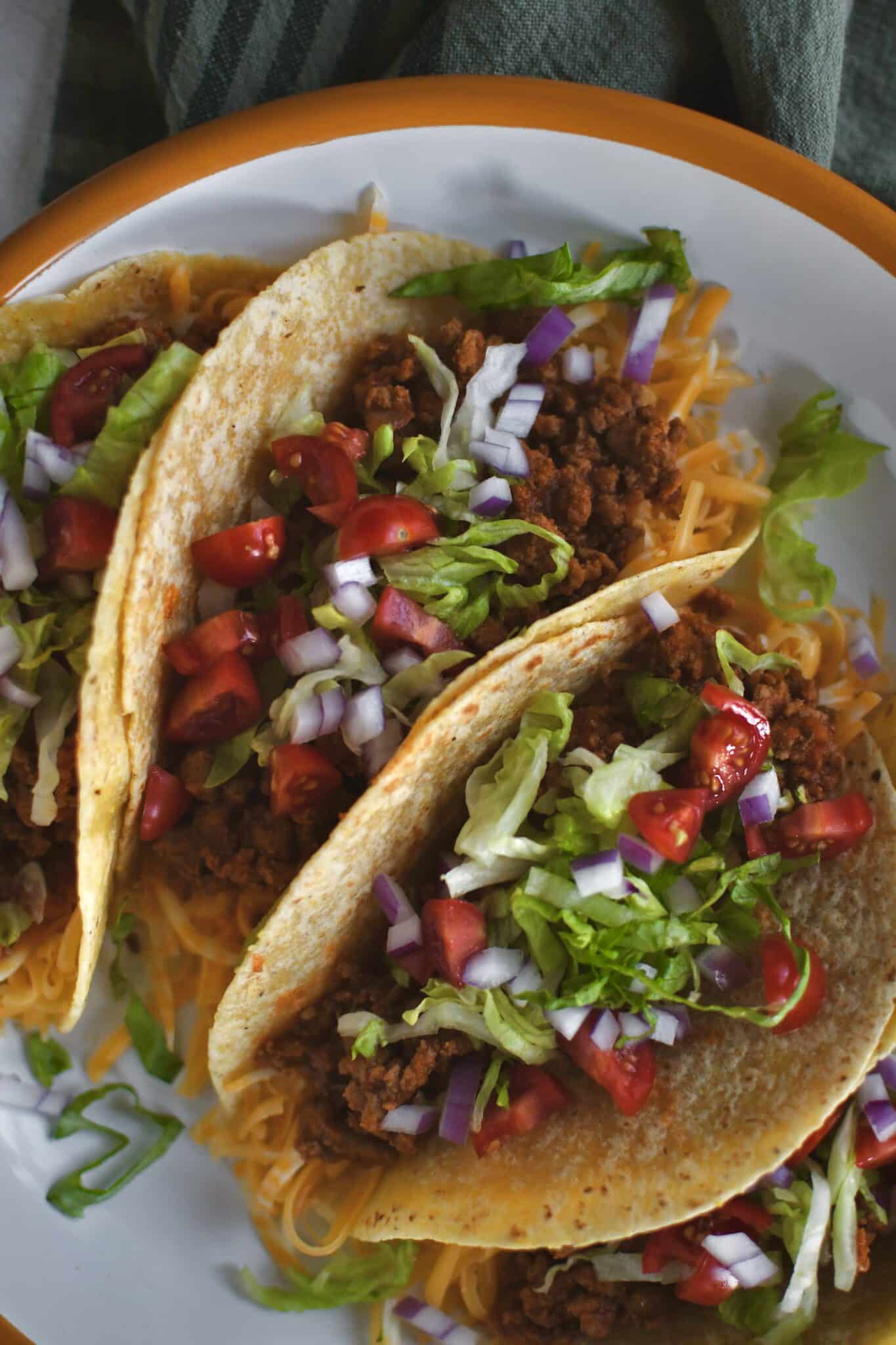 Ground Turkey Tacos lined up on a plate ready to eat.