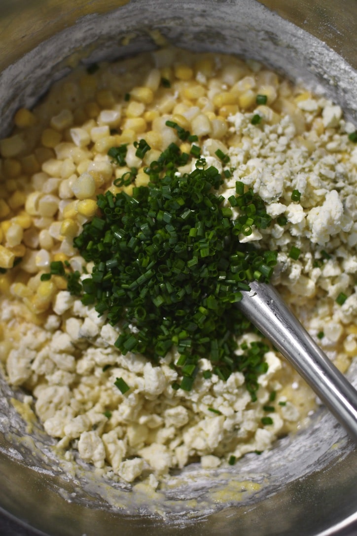 Flour and Cornmeal lightly whisked into the bowl, adding the corn, blue cheese, and chives, ready to fold them in.