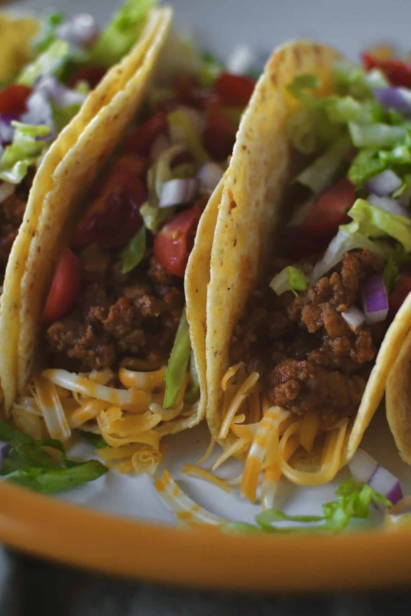 Ground Turkey Tacos lined up on a plate ready to eat.