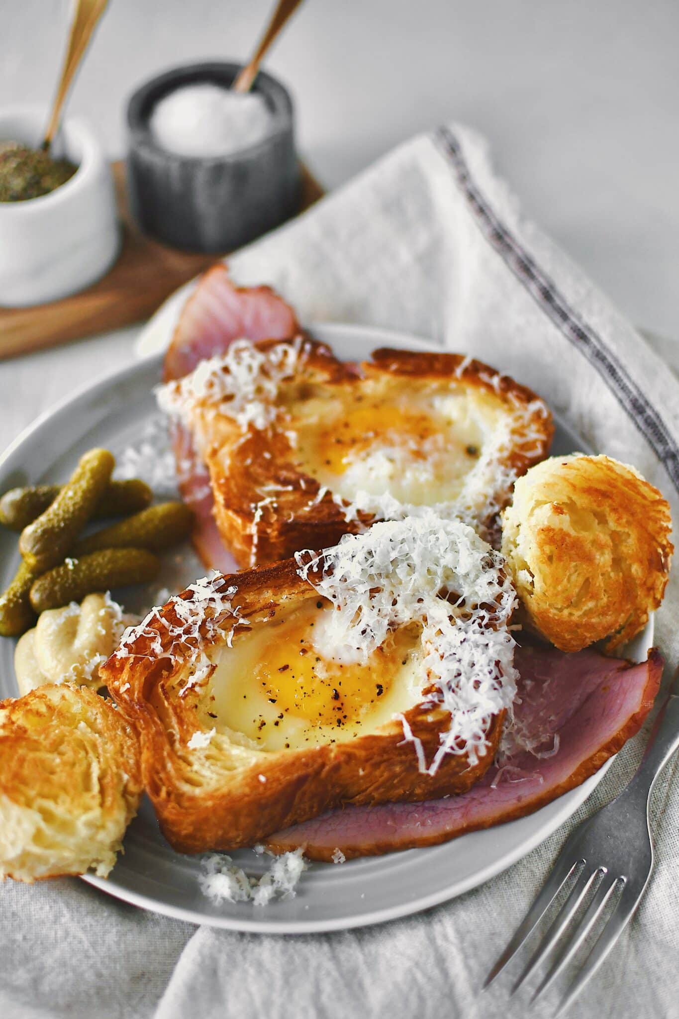 Egg in a Basket served over a ham steak and topped with gruyere cheese.