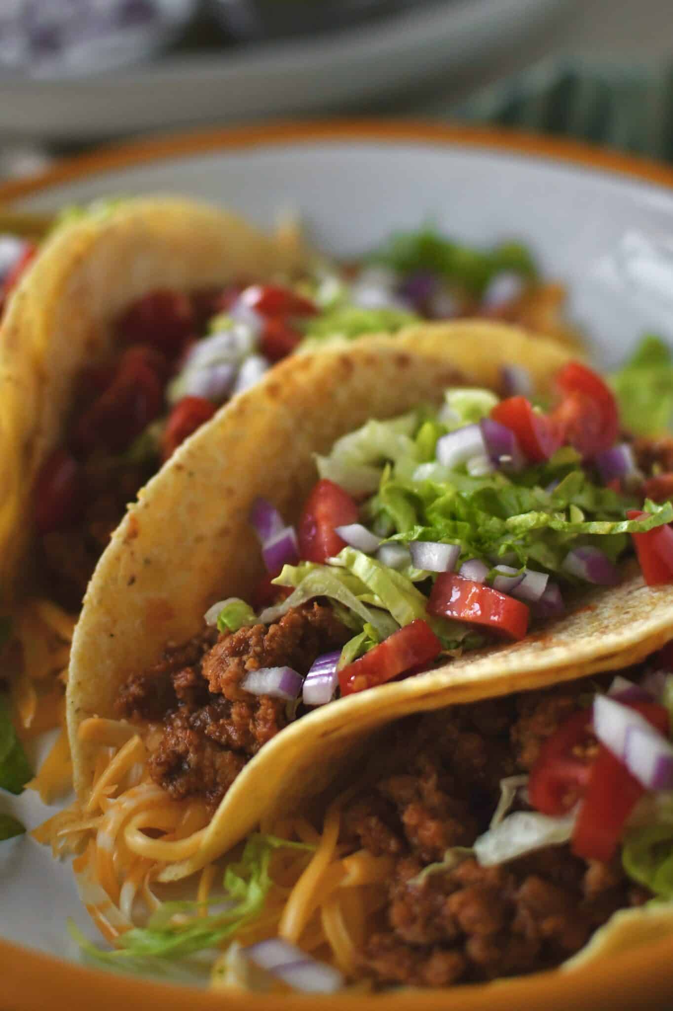 Ground Turkey Tacos lined up on a plate ready to eat.