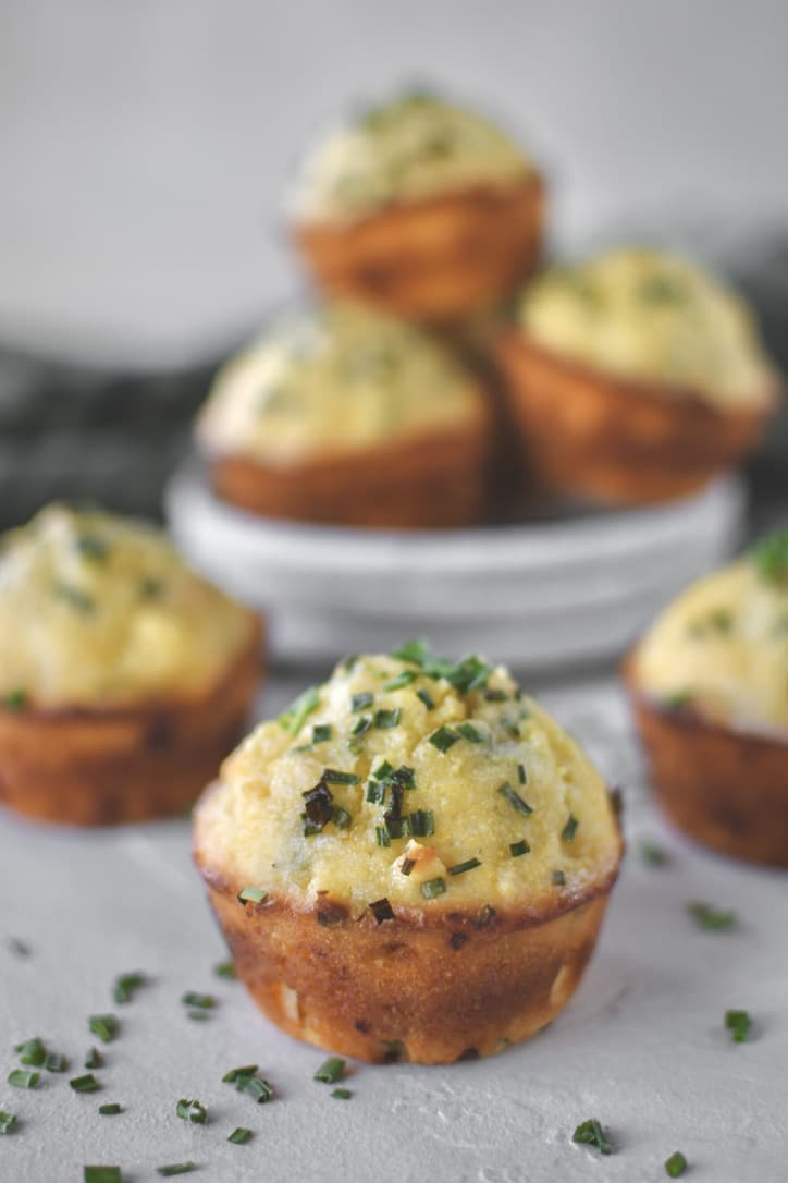 Cornbread Muffins stacked on a plate ready to be eaten.