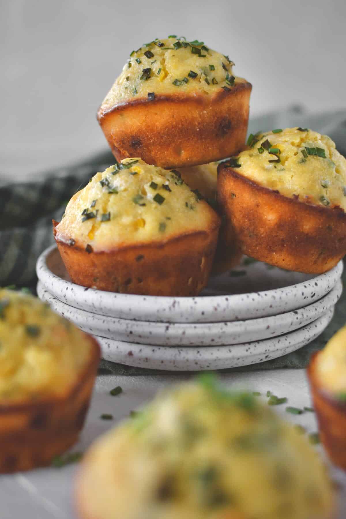 Cornbread Muffins stacked on a plate ready to be eaten.