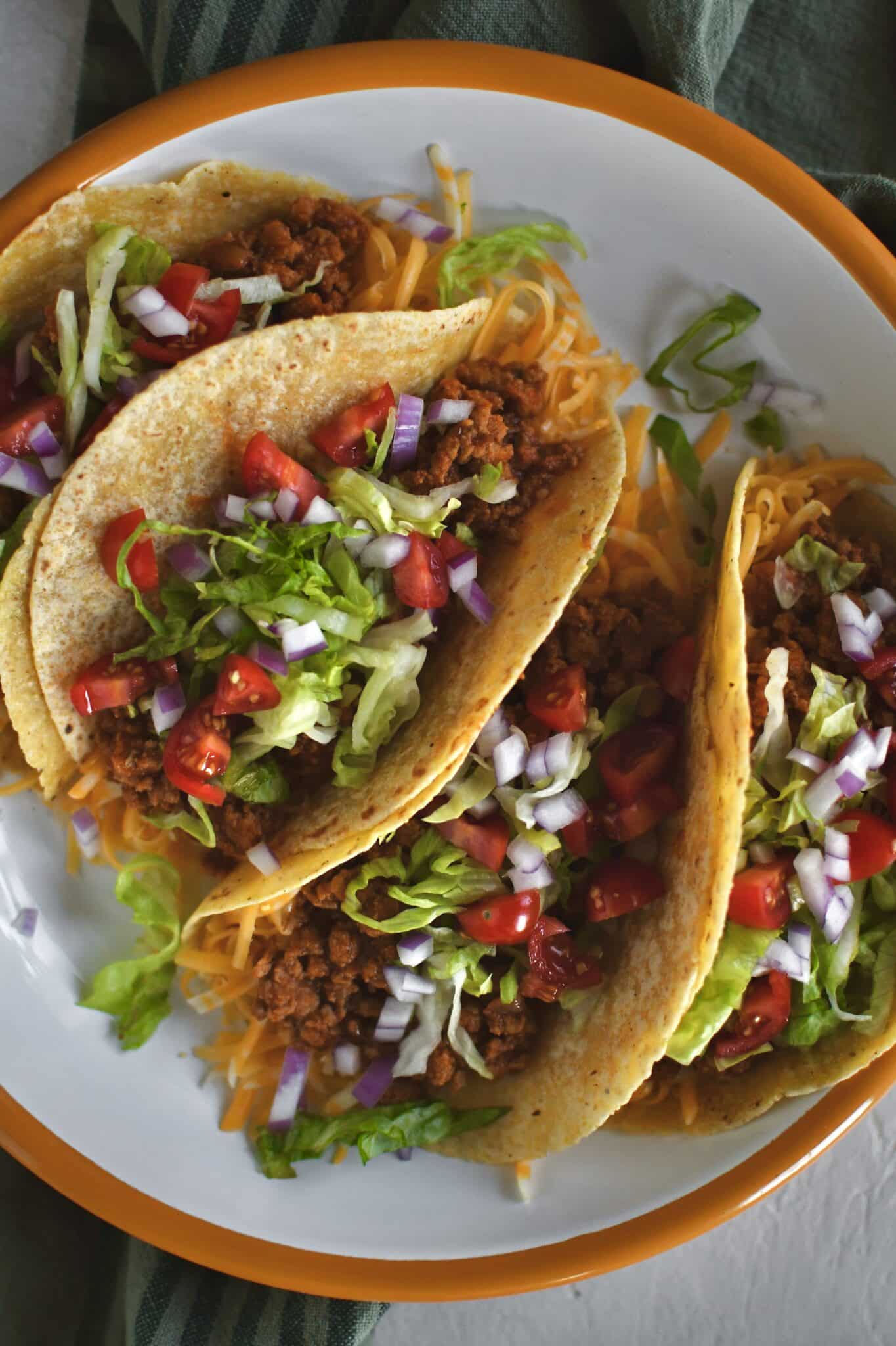 Ground Turkey Tacos lined up on a plate ready to eat.