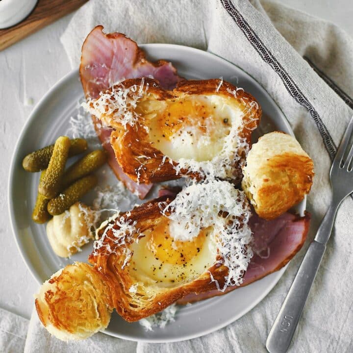 Eggy in a Basket served over a ham steak and topped with gruyere cheese.