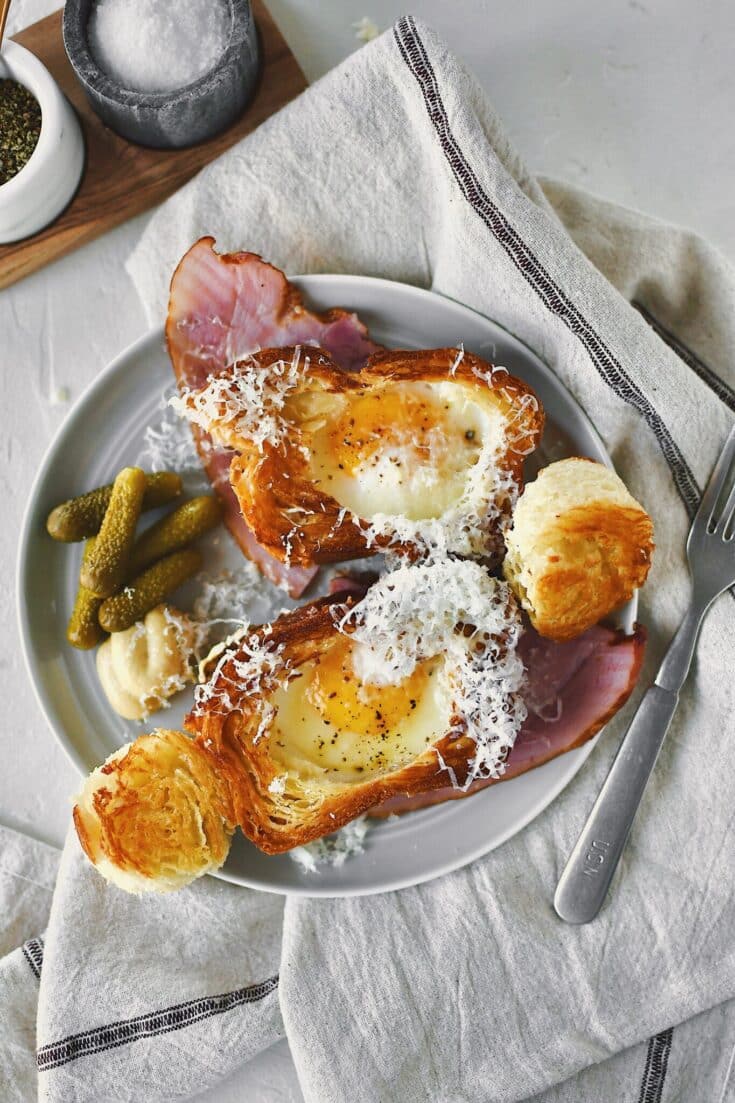 Eggy in a Basket served over a ham steak and topped with gruyere cheese.
