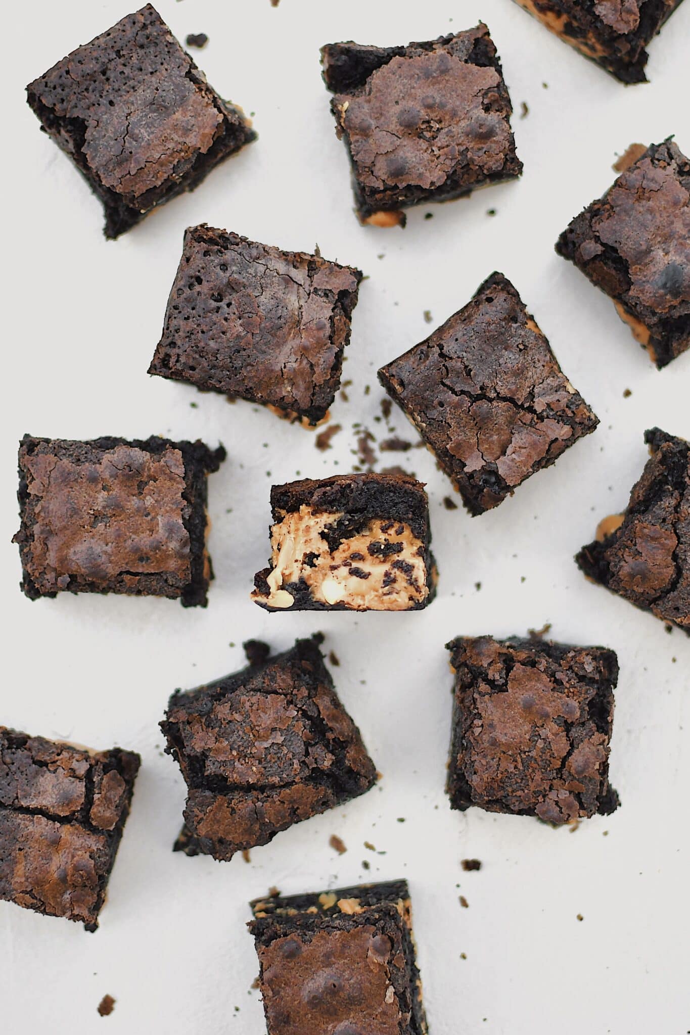 Peanut Butter Brownies scattered on a platter, cut and ready to eat.