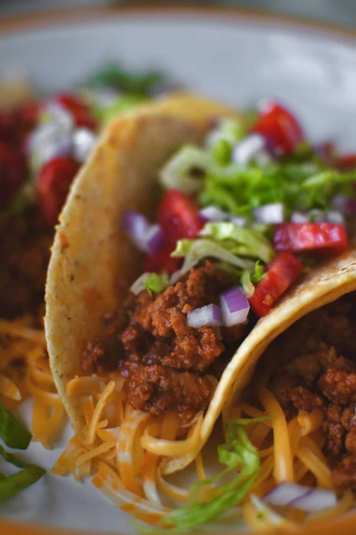 Ground Turkey Tacos lined up on a plate ready to eat.