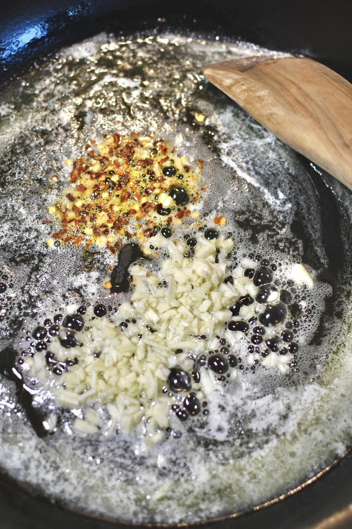 Starting the pasta sauce with melted butter in a large pan with garlic and red pepper flakes.