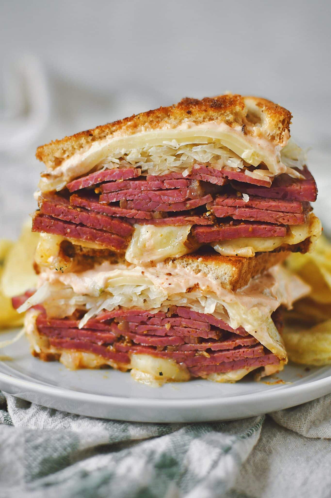 Pastrami used to make a Reuben Sandwich, sliced in half and stacked up.