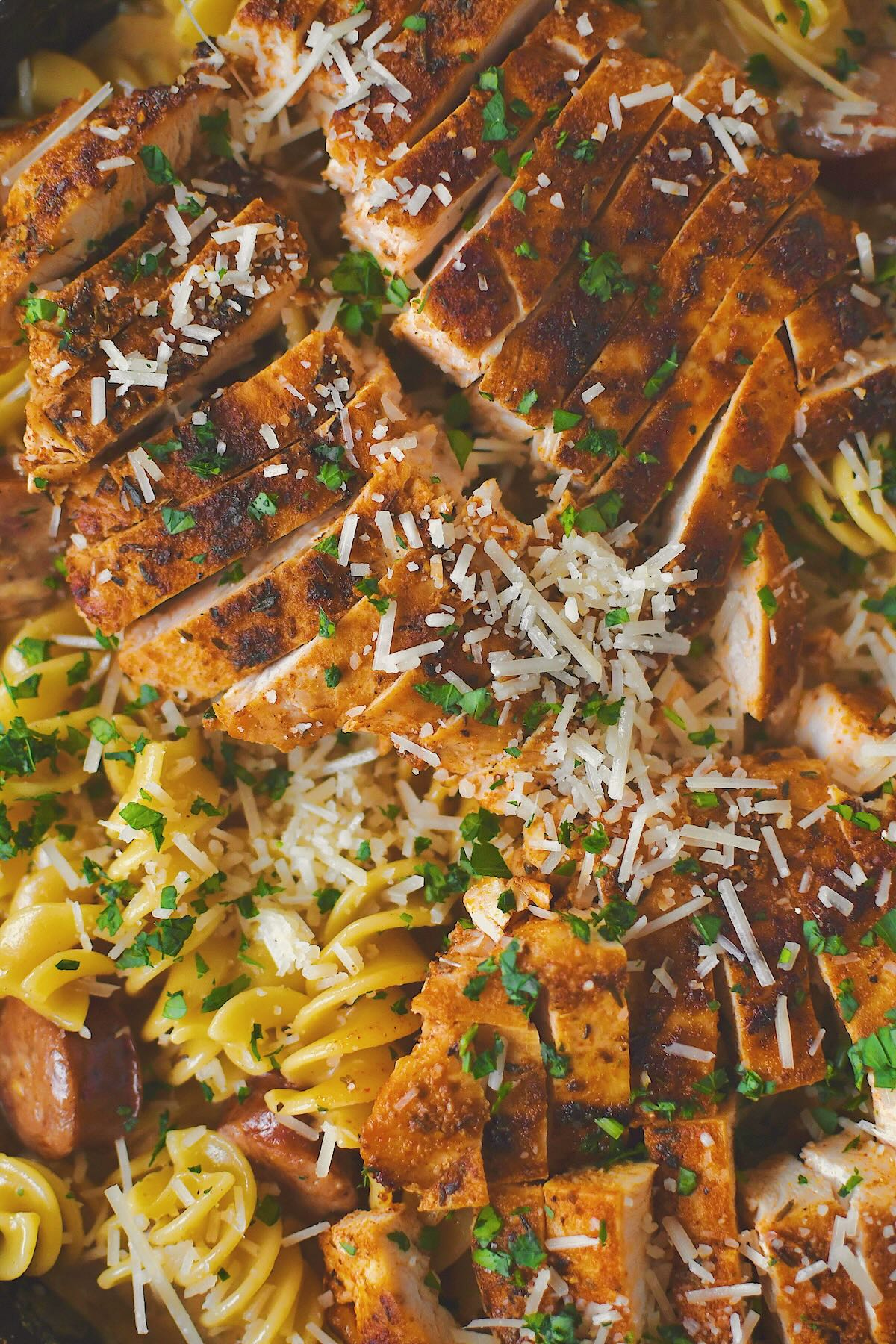 Cajun Chicken Alfredo finished in the pan with chicken on top.