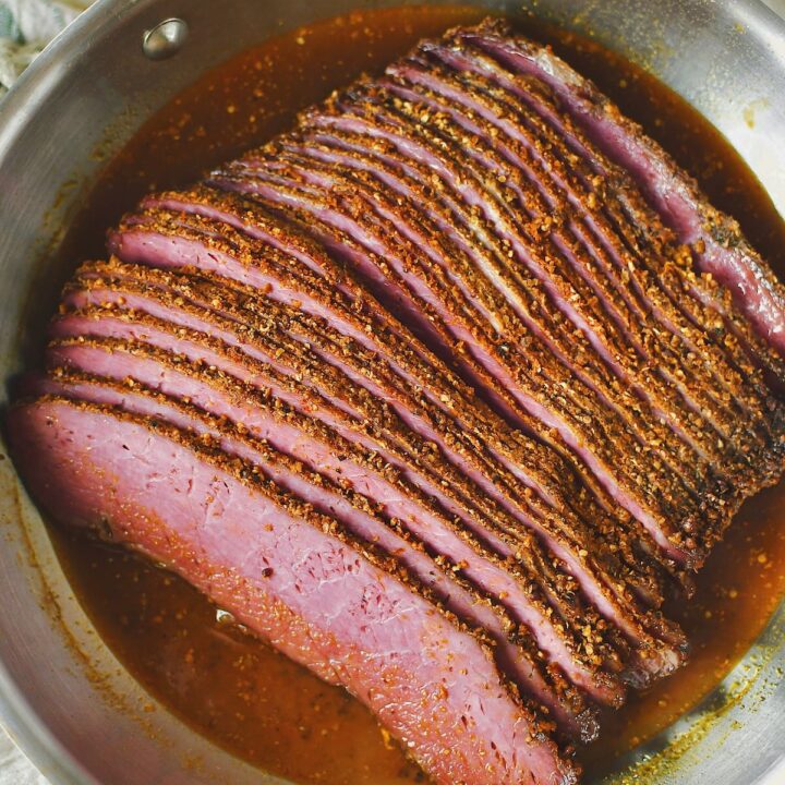 Reheating sliced pastrami in the juices that were saved from roasting.