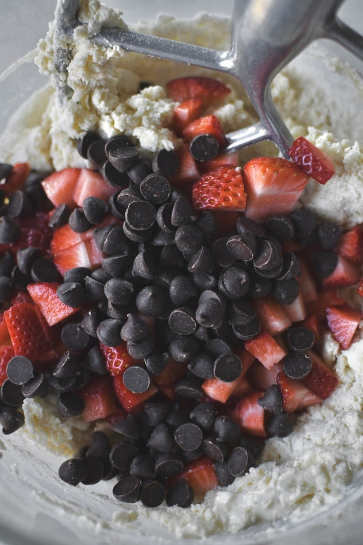 Adding the strawberries and chocolate chips to the scone dough.