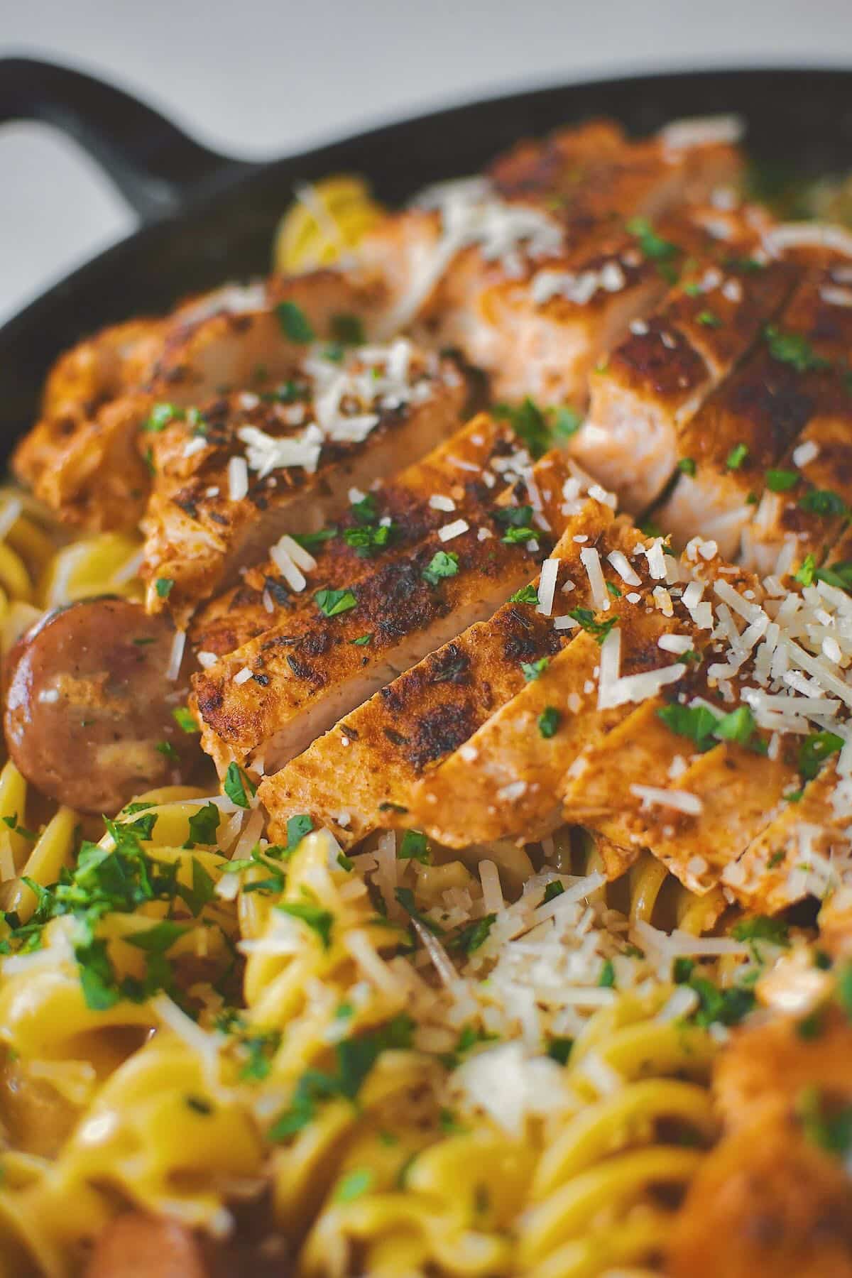 Cajun Chicken Alfredo finished in the pan with chicken on top.