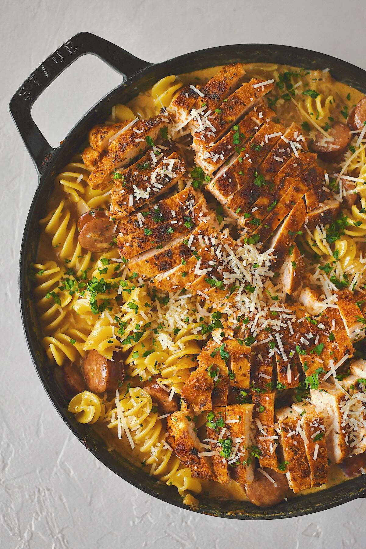 Cajun Chicken Alfredo finished in the pan with chicken on top.