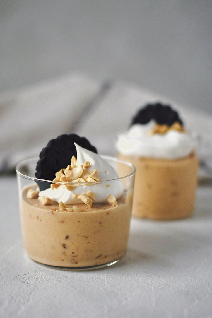 Peanut Butter Mousse in a small cup, topped with whipped cream, peanuts, and a chocolate wafer.