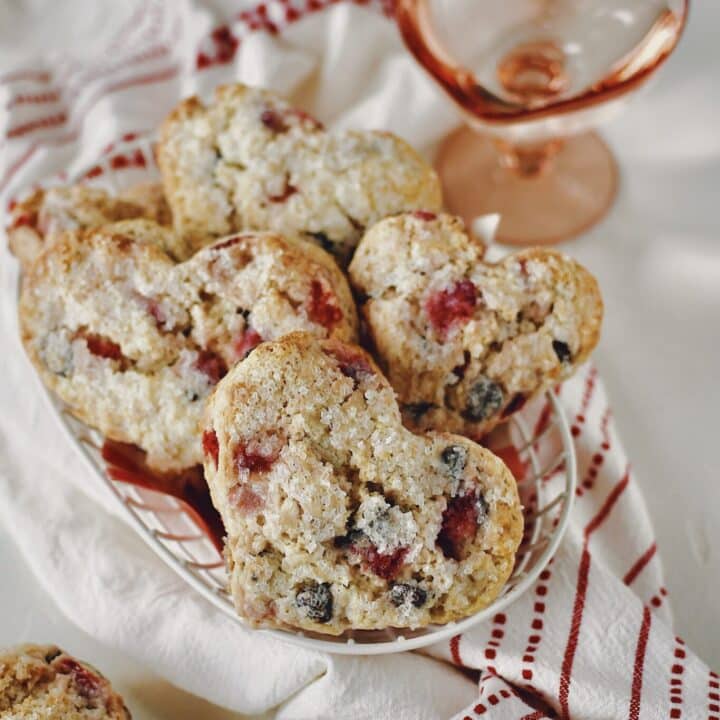 Strawberry Scones that have been cut into the shape of hearts in a basket ready to eat.