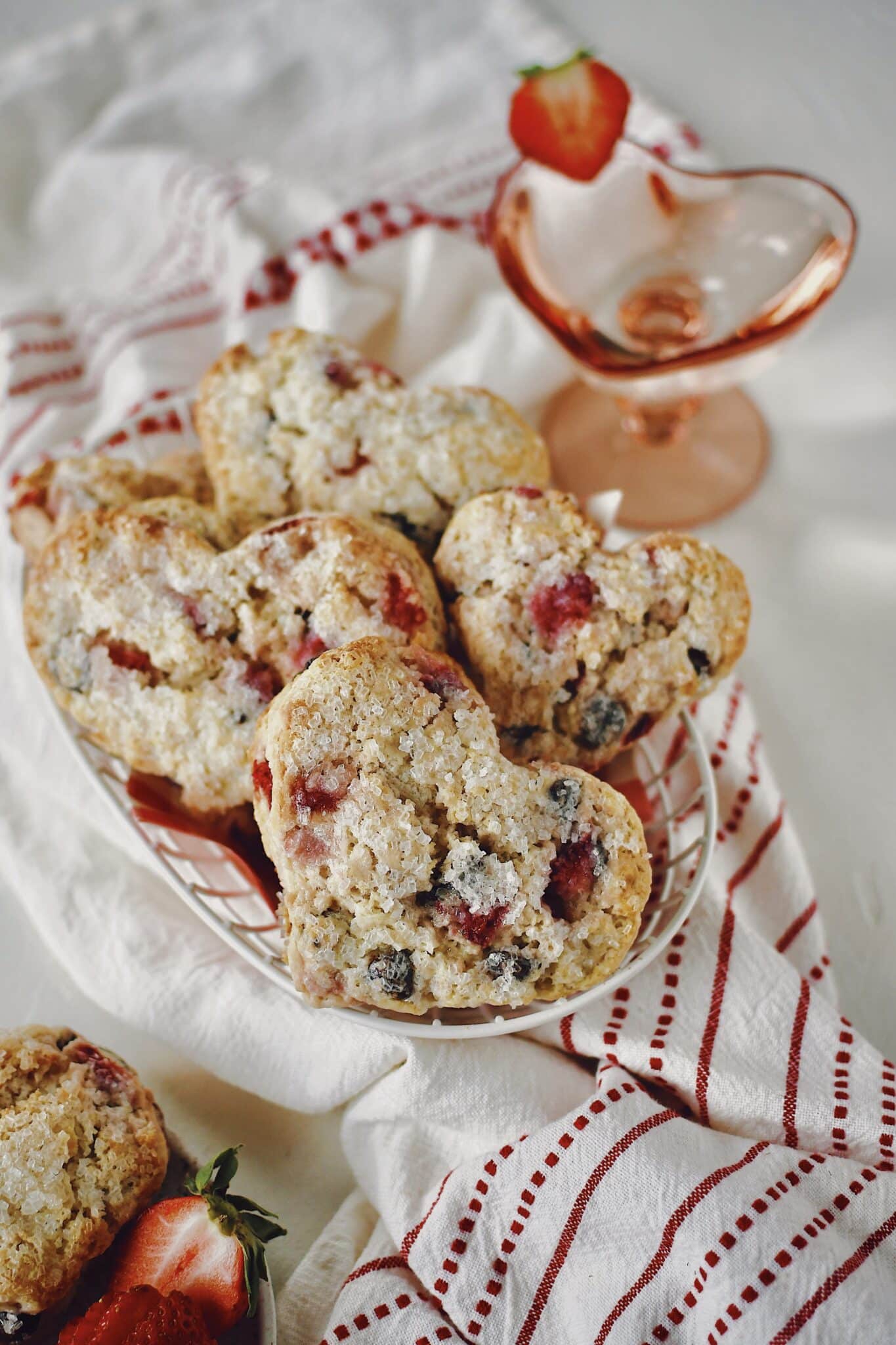Strawberry Scones that have been cut into the shape of hearts in a basket ready to eat.