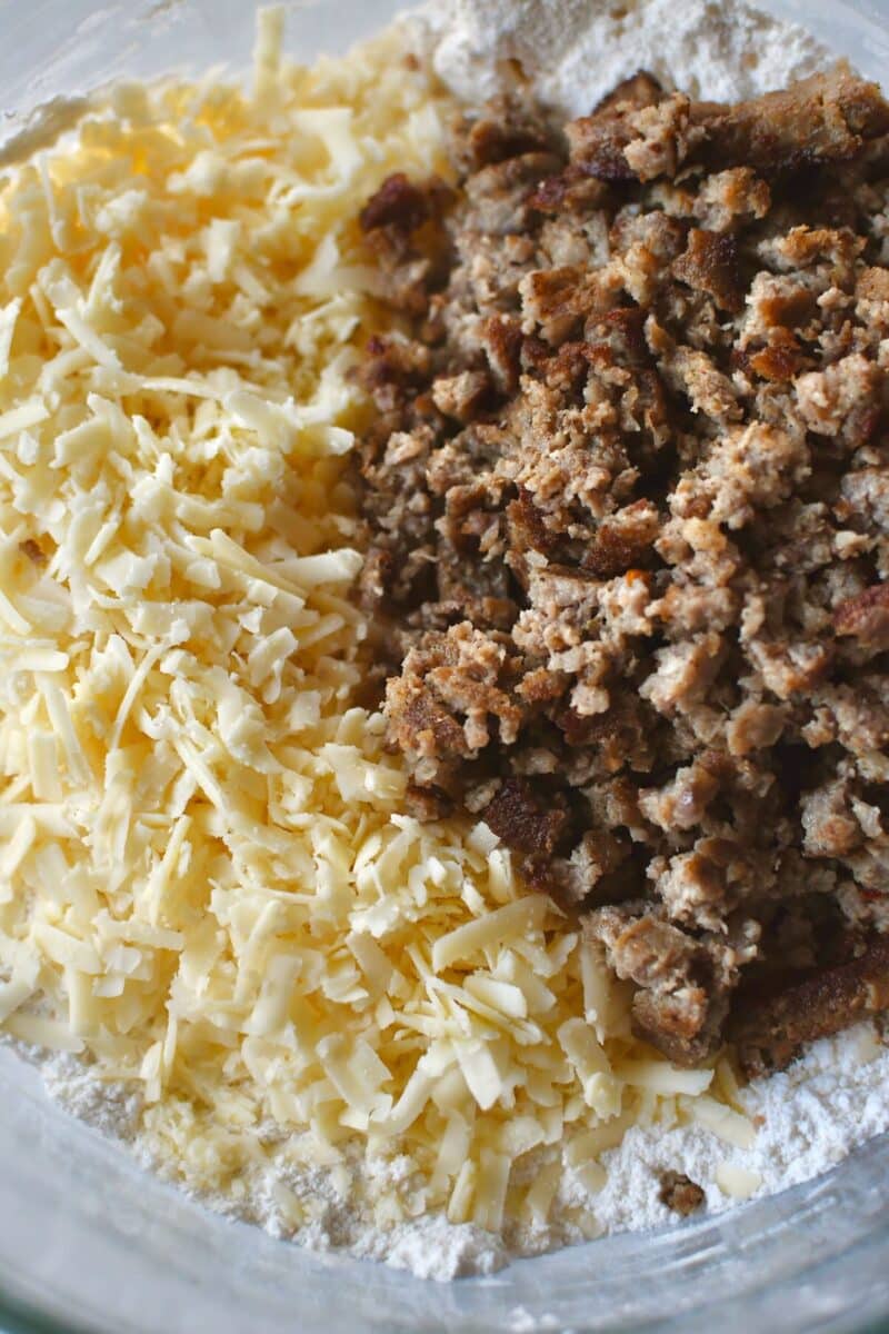 Adding irish cheddar and cooled breakfast sausage to the biscuit dough.