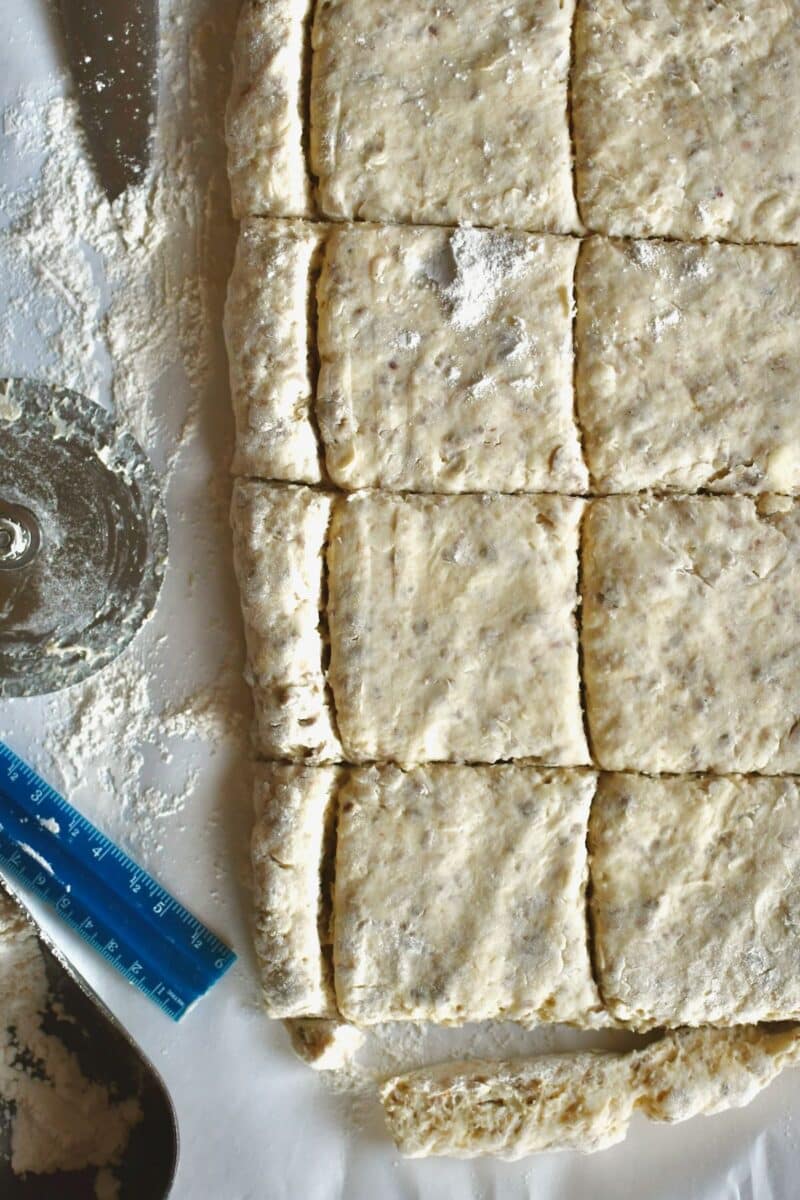 Cut biscuit dough ready to chill and be baked with cheese and egg in it.