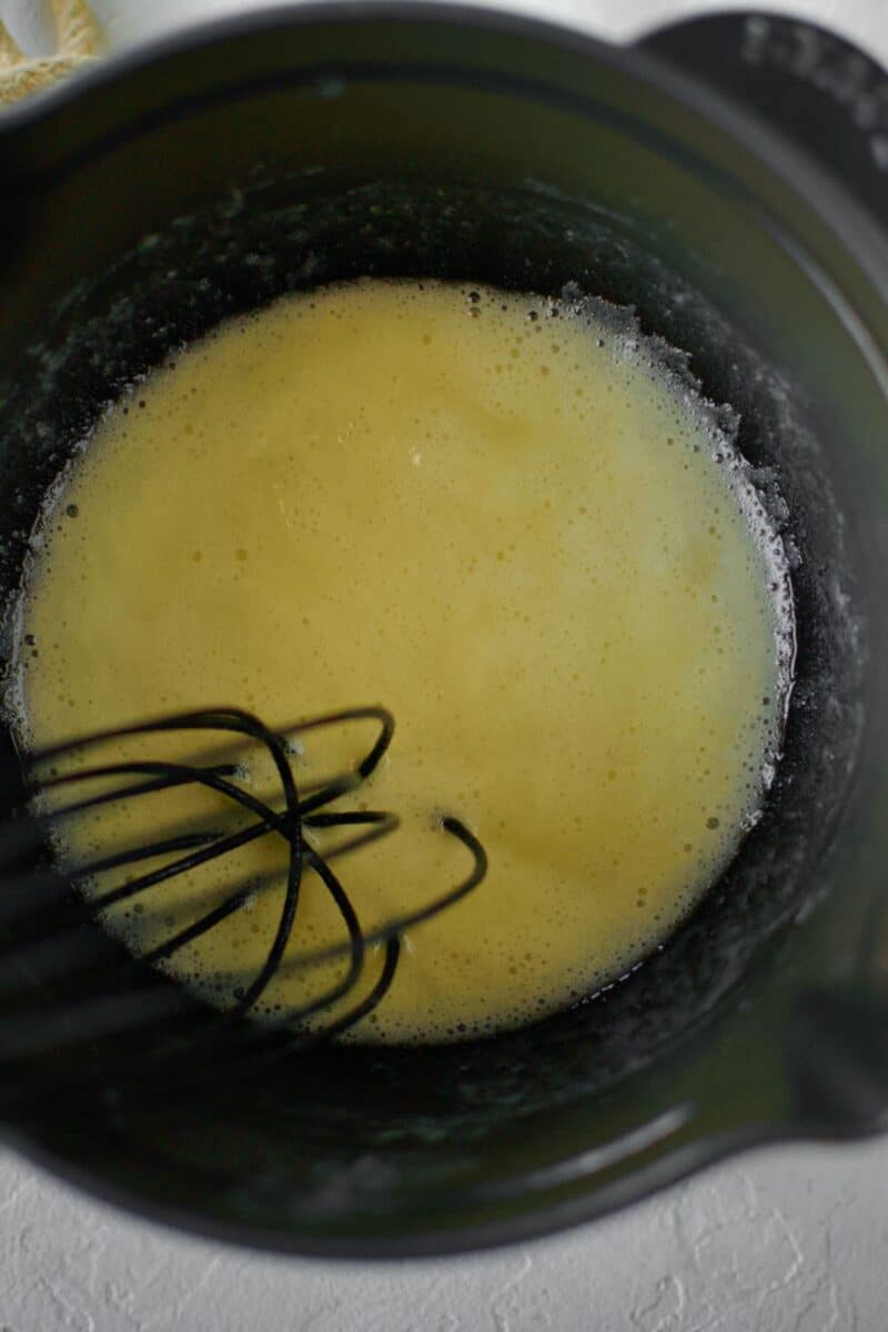 Cooking the butter and flour together to make a roux.