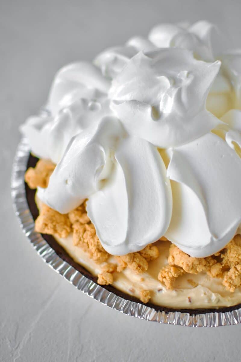 Finishing the pie with some of the crumble topping and more cool whip.