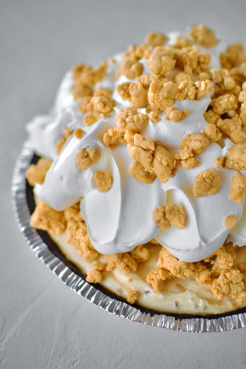 Finishing the pie with some of the crumble topping and more cool whip, and more crumble on top!