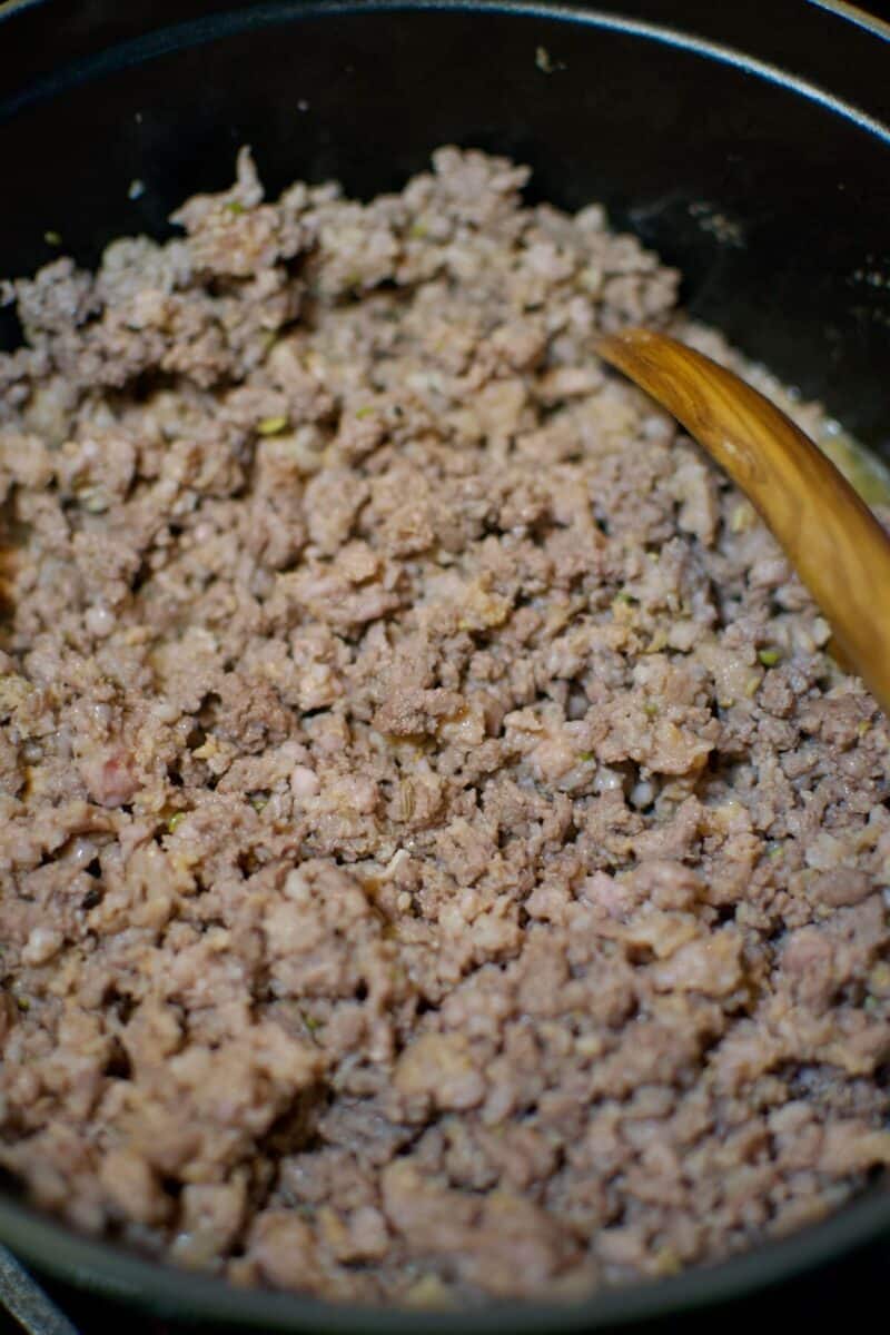 Browning the beef and sausage as the first step of making the soup.