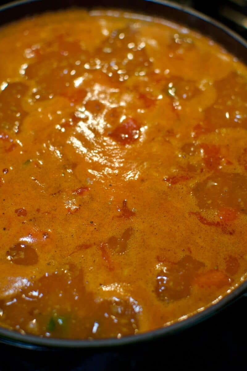 Bringing the soup base to a simmer, before adding the rice.