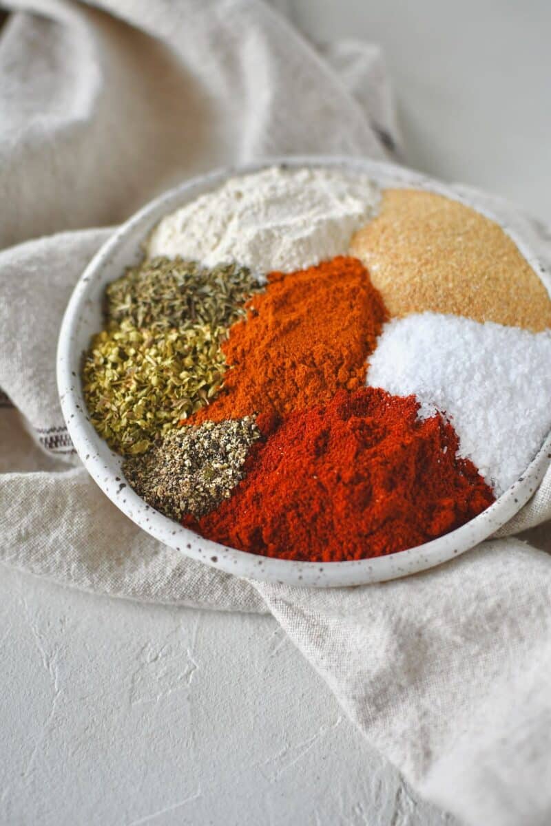 Ingredients for cajun seasoning laid out on a plate.