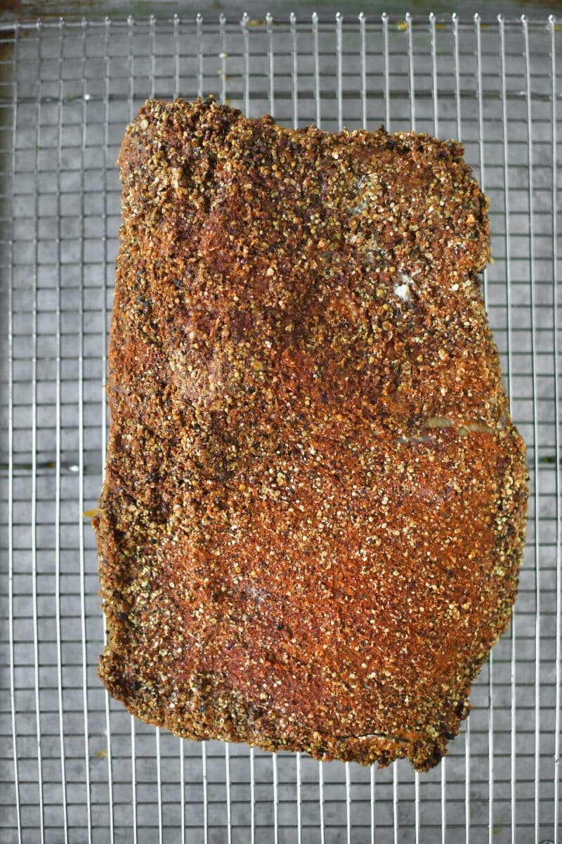 Cooled corned beef brisket, after roasting in the tin foil and seasoned with the pastrami rub.